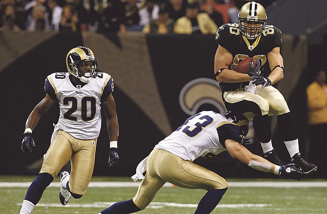 Saints tight end Jimmy Graham tries to leap over Rams safety Craig Dahl as St. Louis' Darian Stewart (20) looks on during Sunday's game in New Orleans. 