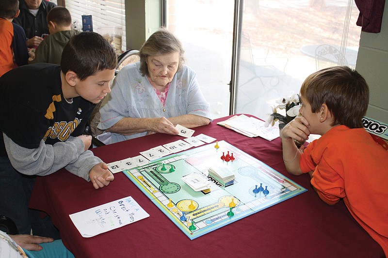 Mandi Steele/FULTON SUN photo: From left, Gabe Williamson, Margaret Wood and Daniel Donald play a game of Sorry at Riverview Nursing Center on Friday. The fourth-grade classes at South Callaway Elementary try to make the trip at least once a year. 