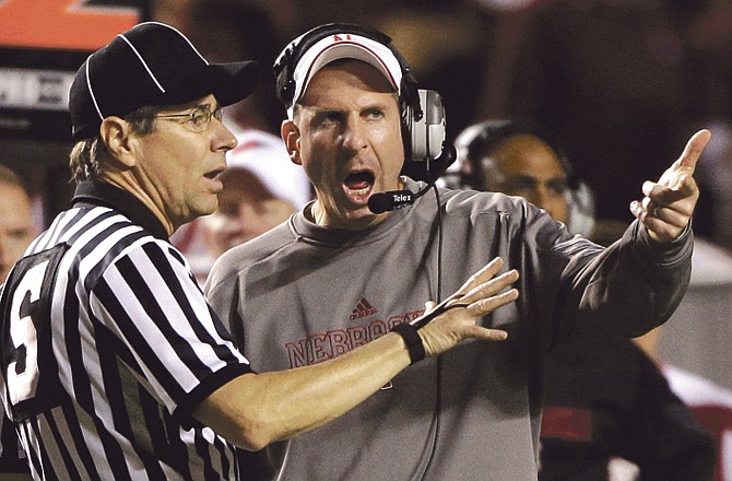 In this Nov. 20, 2010, file photo, Nebraska coach Bo Pelini, right, argues with an official during the third quarter of an NCAA college football game against Texas A&M, in College Station, Texas. 