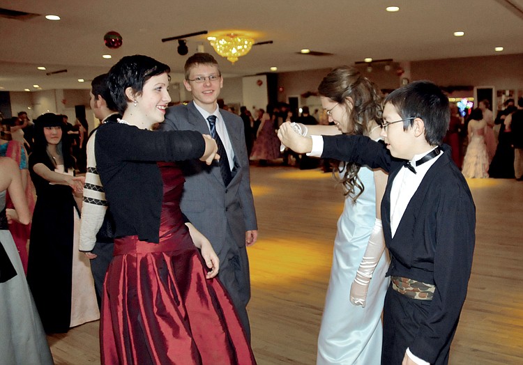 Rosa Hoyle and Alvin Zitting along with Molly and Erik Klebba learn Old English country dances at the Jefferson City Home Educators' Teen Christmas Ball Friday evening at Capital Ritz. To view this and other photographs, please visit www.newstribune.com/photos.