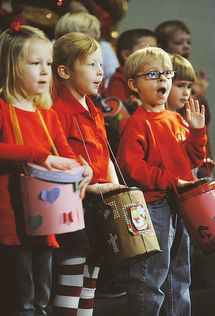 Kindergartners drum the chorus of "Little Drummer Boy" during a morning worship service Friday at Trinity Lutheran Church. The performers made their own drums to accompany the song.