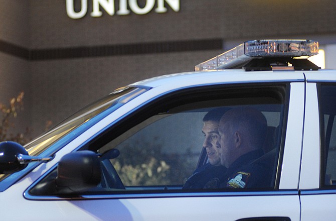 Officers Steve Dappen and Jason Payne look at information on their computer screen as they investigate a robbery at the Missouri Credit Union about 4 p.m. Monday. A well-covered, shielded robber walked in and demanded all the money. No one was injured in the robbery, and investigators and officers from the Jefferson City Police Department are investigating the incident along with the FBI.