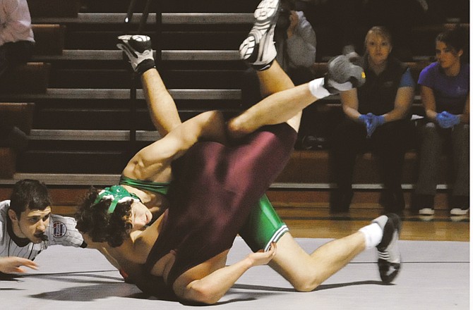 Craig Clark of Blair Oaks works Jacob Wermuth of School of the Osage onto his back during their 171-pound match Tuesday night in Wardsville. To view this and other photographs, please visit www.newstribune.com/photos.