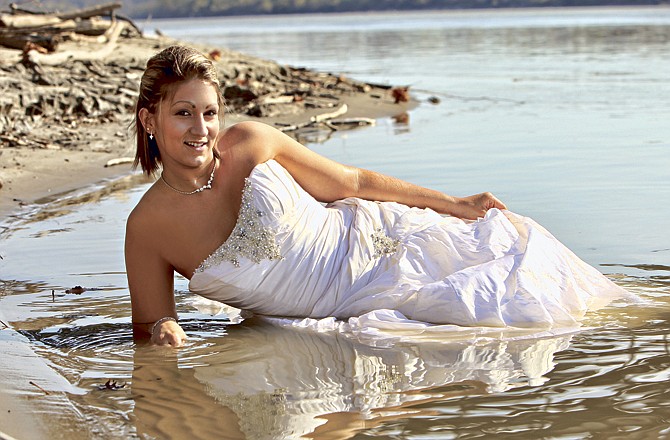 Shane and Danielle Baumhoer took traditional photos in their wedding attire before Danielle waded into the Missouri River in her $1,700 Maggie Sottero gown. 