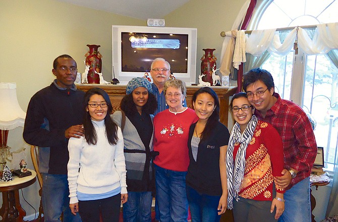 Fulton residents Carolyn and Deane Hulett, center, have participated in Westminster College's foster program for international students for the past four years, serving as a support for exchange students. The couple recently hosted several of "their girls" and friends for Christmas candy-making.                      
