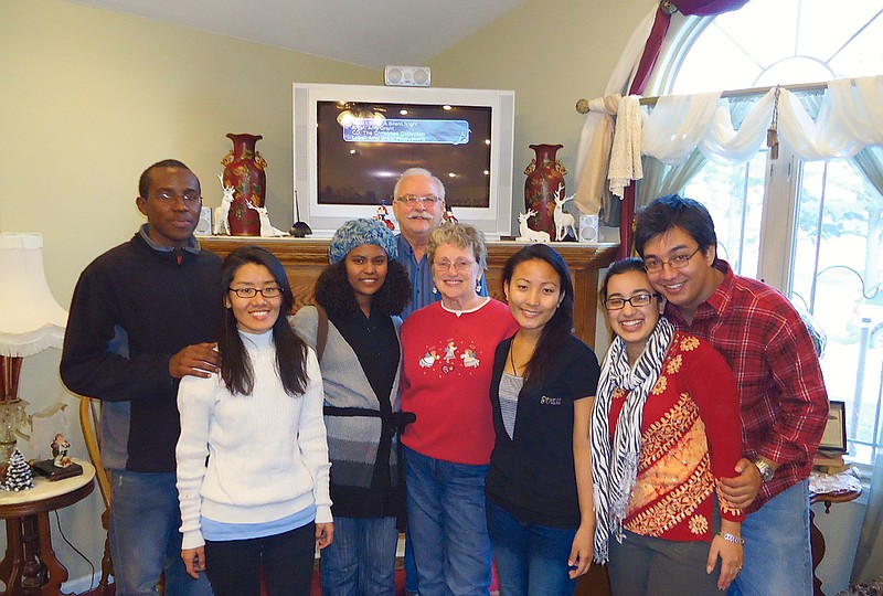 Contributed photo: Fulton residents Carolyn and Deane Hulett have participated in Westminster College's foster program for international students for the past four years, serving as a support for exchange students. The couple recently hosted several of "their girls" and friends for Christmas candy-making. (From left) Edward, Dawa Dolma Sherpa, Muludrhan Gebrekidan, Deane Hulett, Carolyn Hulett, Dawa Pashi Sherpa, Sneha Bhandari and KC.