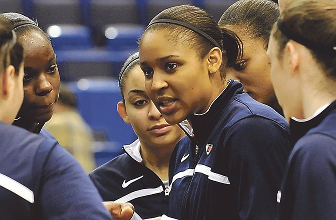 Connecticut forward Maya Moore, center, talks to her teammates before an NCAA college basketball game against Florida State. Moore got her hoops start in Jefferson City. 