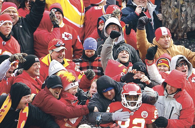 Chiefs wide receiver Dwayne Bowe (82) celebrates in the stands after scoring a touchdown in the second quarter of Sunday's 34-14 win over the Titans at Arrowhead Stadium. The victory, coupled with San Diego's loss later in the day at Cincinnati, clinched the AFC West title for Kansas City. 