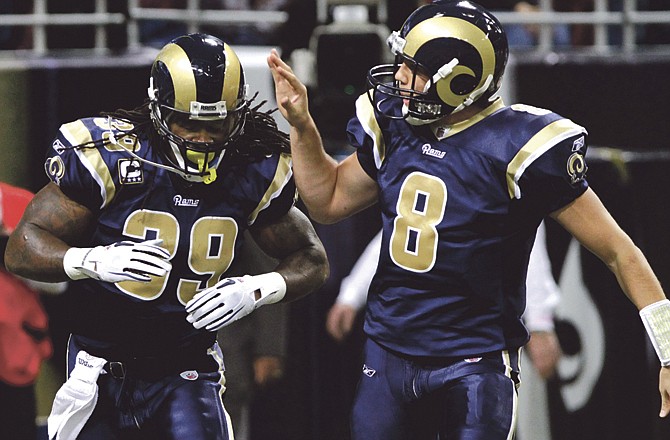 Rams quarterback Sam Bradford (8) congratulates Steven Jackson after his 1-yard touchdown run during the first quarter of Sunday's 25-17 victory over the 49ers at the Edward Jones Dome. 
