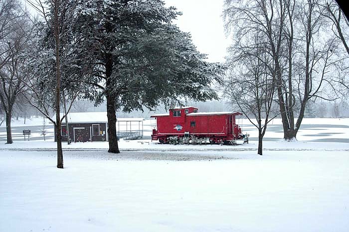 Proctor Park's red caboose contrasts with the snow on a  white Christmas for 2010.