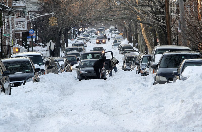 Cars are stuck on the unplowed 56th Street on Wednesday in the Boro Park neighborhood of Brooklyn, N.Y. 