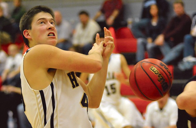 Clay Schwinke of Helias tries to gain control of the basketball during Thursday night's third-place game against Evangelical Christian at Fleming Fieldhouse.