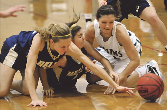 Helias teammates Elizabeth Grothoff (left) and Taylor Hagenhoff (middle) battle with a Rock Bridge player for control of the ball during Wednesday's game at Rackers Fieldhouse. 