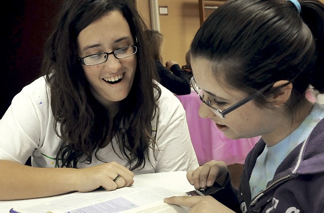 
Kalee Hall, left, and Katie Hughes work on a project together as part of the mentor program for Lighthouse Preparatory Academy. 