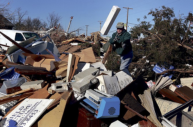 Architect John W. Littlefield salvages 35 years' worth of architecture plans from a storage garage Saturday in Sunset Hills, Mo., after a New Year's Eve storm severely damaged a number of homes in the area. 