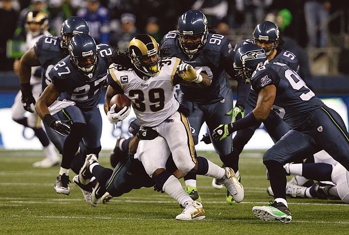 A horde of Seahawks defenders close in on Rams running back Steven Jackson during Sunday night's game in Seattle. 