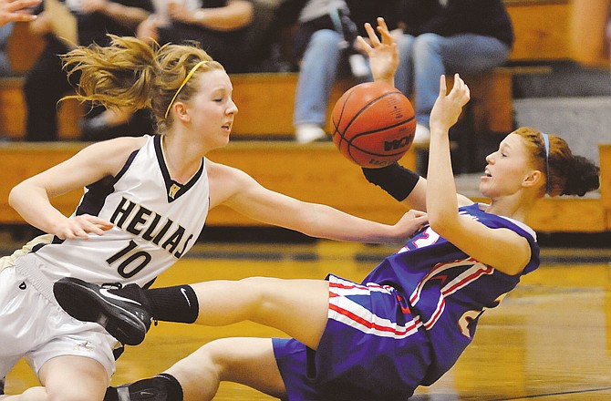 Helias' Katie Sauer and California's Beth Crow battle for a loose ball during Tuesday night's game at Rackers Fieldhouse. To view this and other photographs, please visit www.newstribune.com/photos.