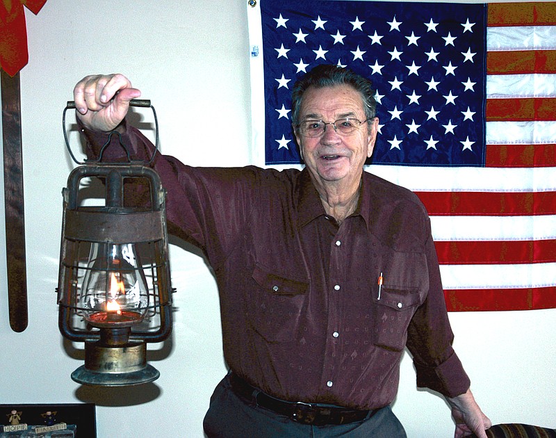 Derry Brownfield demonstrates that the century old brass fire lantern used by his grandfather George Stegner when he was California Fire Chief still works.