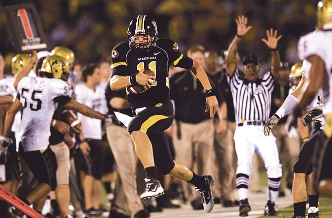 Missouri quarterback Blaine Gabbert runs out of bounds during a game this season against Colorado at Faurot Field. The junior announced Monday he is making himself eligible for the NFL draft. 