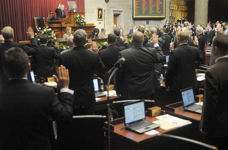 Missouri Supreme Court Chief Justice William Ray Price, center at dais, swears in members of the House of Representatives Wednesday at the Capitol. The 2011 Missouri General Assembly convened Wednesday and will adjourn its regular session at 6 p.m. Friday, May 13.