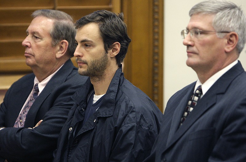 Matthew Hoffman, center, listens to the judge during his arraignment Thursday in the Knox County Court of Common Pleas in Mount Vernon, Ohio. Hoffman pleaded guilty to killing three people and stuffing their bodies in a hollow tree.