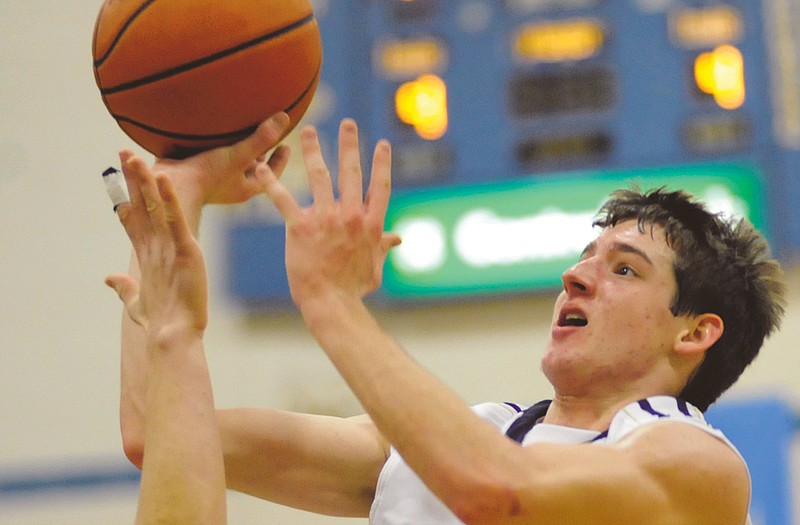 Dylan Gish of Helias drives to the bucket during Friday night's game against St. Dominic at Rackers Fieldhouse. 