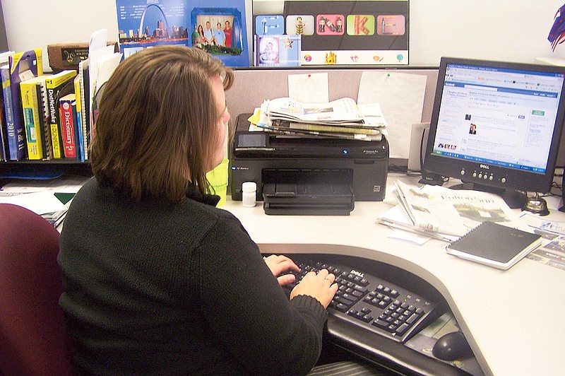 Stephanie Backus/FULTON SUN photo: Kristen Zeimet, Kingdom of Callaway Chamber of Commerce PR and Membership coordinator, updates the Chamber's Facebook page on Thursday. Local businesses are relying on Facebook business pages to reach a new audience.