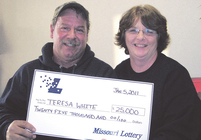 Contributed photo: Teresa White and her husband David hold a $25,000 check from the Missouri Lottery she won on New Year's Day playing Keno at the Fulton Bowling Center.