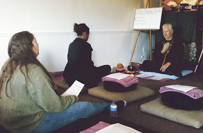 
Jefferson City residents Laura Wenzlick, left, and Nicole Saltzman meditate with Buddhist priest William Edwards at the Vipassana Buddhist Church and Center for Buddhist Development in Jefferson City on Saturday. The center held a three-day meditation retreat this weekend to help people learn to focus and deal with stress. 