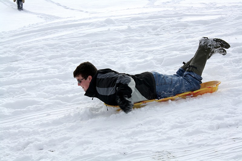 Mandi Steele/FULTON SUN photo: Zach Welch, 12 of Fulton, sleds head first through the snow at Memorial Park. Youth were out Tuesday enjoying their snow day off of school.
