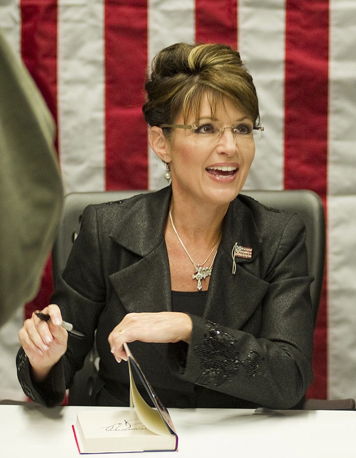 Sarah Palin signs copies of her new book, "America By Heart," in Little Rock, Ark. Palin has posted a nearly eight-minute video on her Facebook page condemning those who blame political rhetoric for the Arizona shooting that gravely wounded U.S. Rep. Gabrielle Giffords.  In the video posted Wednesday, Dec. 12, 2010, the 2008 GOP vice presidential candidate said vigorous debates are a cherished tradition. But she said after the election, both sides find common ground, even though they disagree. 