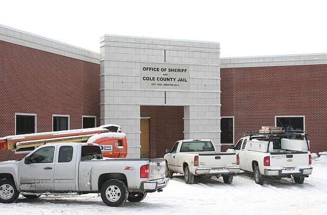 Contractors' trucks surround the main entrance to the new county jail. The target finish date for the new facility is April 15.
