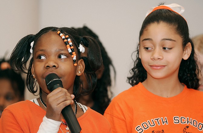 South School students Jasmine Lett, left, and Hope Lewis provide a musical interlude with schoolmates during Friday's Martin Luther King Day of Service Ceremony at the Governor Office Building. 