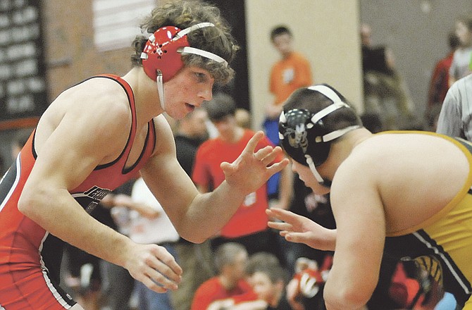 Jefferson City's Jared Johnson (left), shown during action Saturday at the Capital City Invitational, captured first place in the 189-pound weight class. 