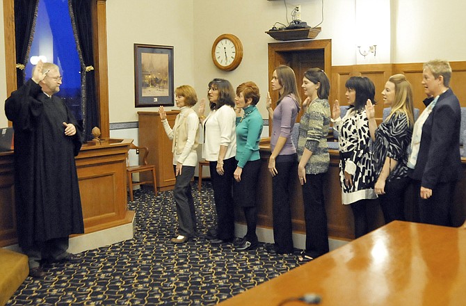 Eight volunteers (of 10 total) are sworn in by Judge Jon Beetem, left, as Court Appointed Special Advocates for children. The CASA program features 40 hours of training to help people become advocates for the best interest of the abused or neglected child in the 19th Judical Circuit of Missouri.
