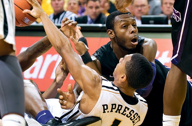 Jacob Pullen of Kansas State and Phil Pressey of Missouri battle for a loose ball during the second half of Monday's game at Mizzou Arena.