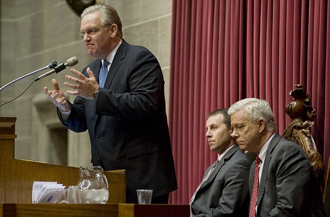 Missouri Gov. Jay Nixon, left, gives his state of the state address as Lt. Gov. Peter Kinder, right, and Speaker of the House Steven Tilley, center, listen Wednesday during a joint session of the House and Senate at the Capitol.