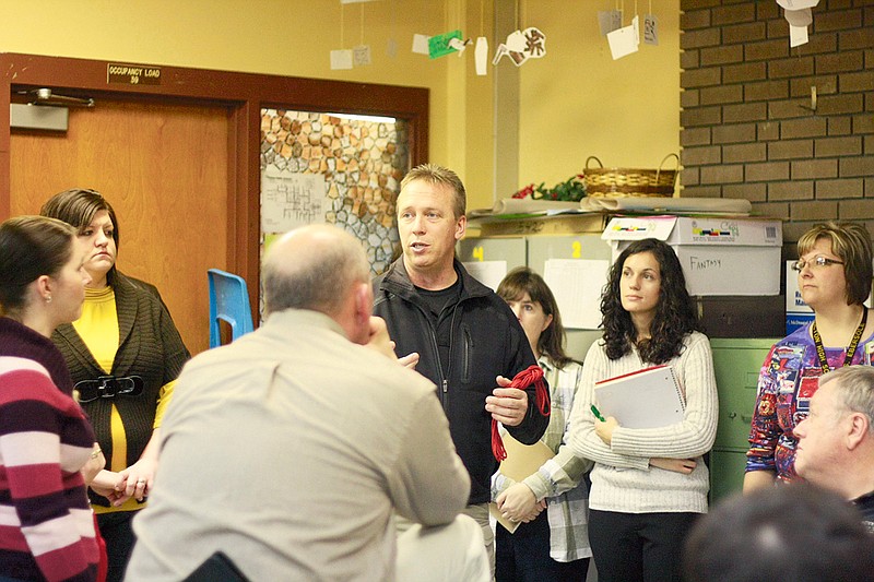 Stephanie Backus/FULTON SUN photo: Mark Warren with Strategos International talks to teachers in a Fulton High School classroom about the ways they can lock down the classroom if a shooter were to attack the school.