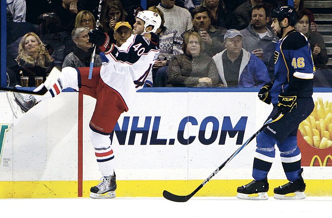 Columbus Blue Jackets' Jared Boll, left, celebrates after scoring as St. Louis Blues' Roman Polak, of the Czech Republic, looks on during the second period of an NHL hockey game, Saturday, Jan. 22, 2011, in St. Louis.