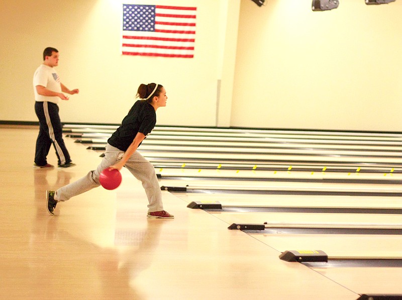 Stephanie Backus/FULTON SUN photo: South Callaway High School student Kelsey Hickman, 17. sends her ball down the lane at Fulton Bowling Center last Wednesday.  The high school P.E. class took a field trip to the center to practice their bowling skills.