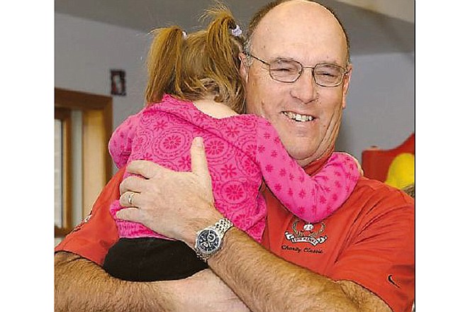 In this file photo from Dec. 22, 2010, Tom Henke gets a hug from an appreciative Special Learning Center student in Jefferson City after presenting a $52,500 check representing the proceeds from Henke's annual golf tournament. As a former pitcher for the Toronto Blue Jays, Henke was selected Monday to be inducted into the Canadian Baseball Hall of Fame.