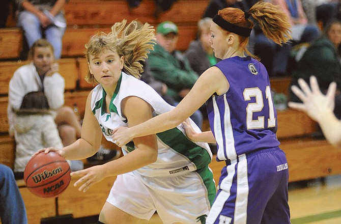 Blair Oaks' Amy Dorge (left) drives the ball past Hallsville's Adrian Long during Tuesday's game in Wardsville.