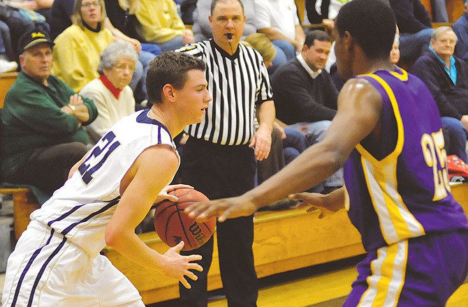 Dean Wiley of Helias drives past a Hickman defender during Wednesday night's game against Hickman at Rackers Fieldhouse. To view this and other photographs, please visit www.newstribune.com/photos.