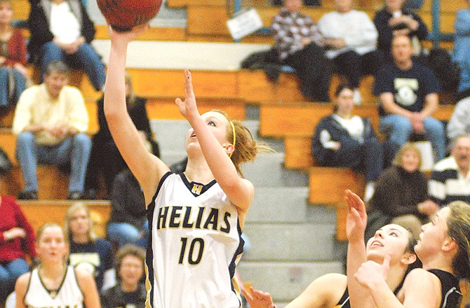 Katie Sauer of Helias goes in for a layup during the first quarter of Thursday's game against Sedalia Smith-Cotton at Rackers Fieldhouse.