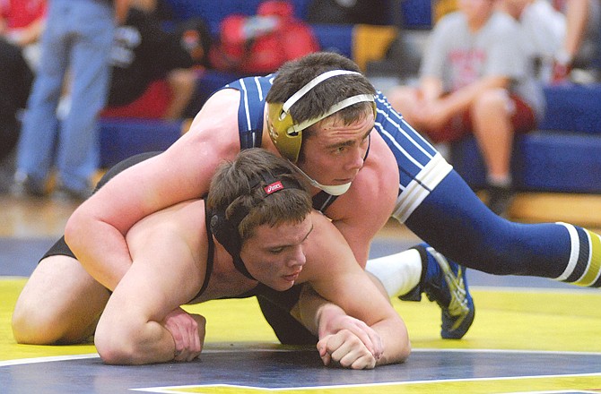 Luke Yarnell of Helias wrestles Austin Hudson of Hannibal in the 171-pound match Thursday night at Helias Gym.