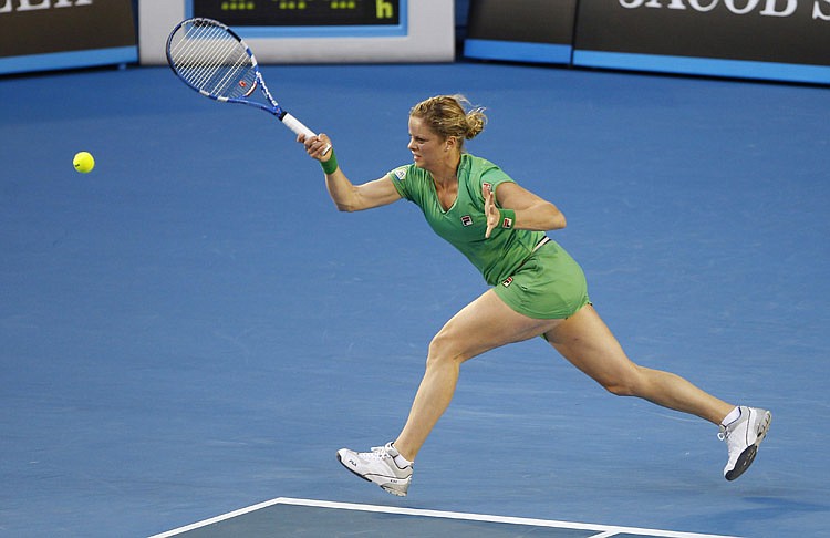 Belgium's Kim Clijsters makes a forehand return to China's Li Na during the women's singles final at the Australian Open tennis championships in Melbourne, Australia, Saturday, Jan. 29, 2011. (AP Photo/Vincent Thian)