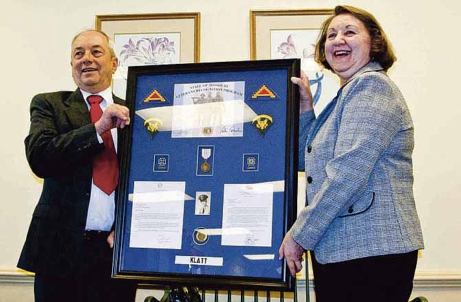 Ronald Klatt, left, was presented the Missouri Vietnam Veterans' Recognition by his wife, Ruth Ann, during a brief ceremony at the Central Mortgage Company's Jefferson City office. 