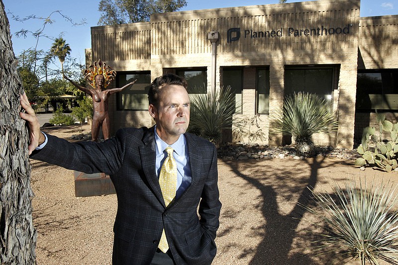 Bryan Howard, president and CEO of Planned Parenthood Arizona, Inc., poses in front of a Planned Parenthood facility in Tucson, Ariz. An undercover video taken at a Planned Parenthood and seeking to discredit it, was released Tuesday.