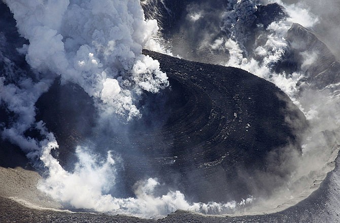 A dome of lava grows larger Monday inside the crater of Mount Shinmoedake in the Kirishimna range on Japan's southernmost main island of Kyushu. The volcano erupted Tuesday with its biggest explosion yet.