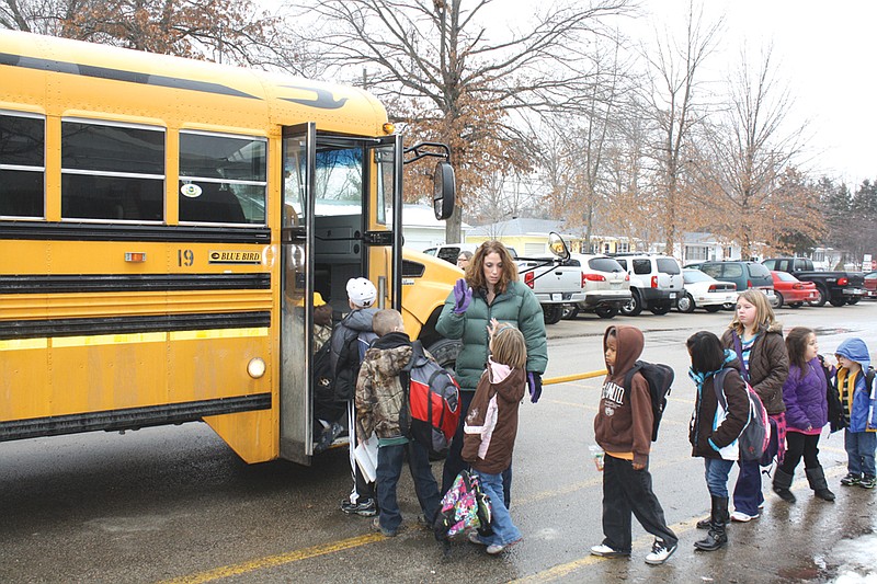 Mandi Steele/FULTON SUN photo: McIntire Elementary School Principal Beth Houf helps students depart Monday afternoon. Schools called for an early out day to make sure students arrived home safely before forecasted ice and heavy snow hit.